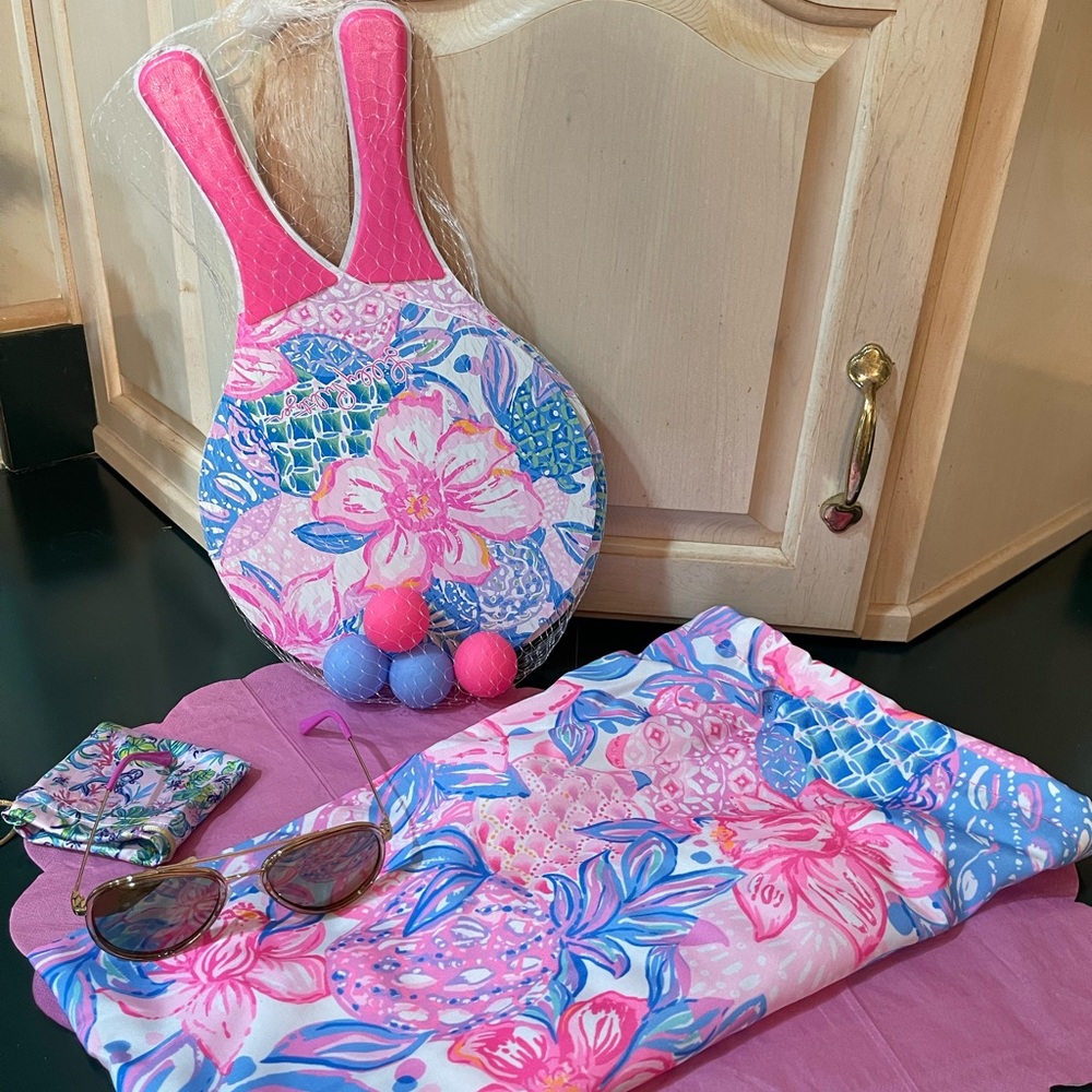 Lilly Pulitzer has you ready for fun. A paddle tennis game and some sun glasses.